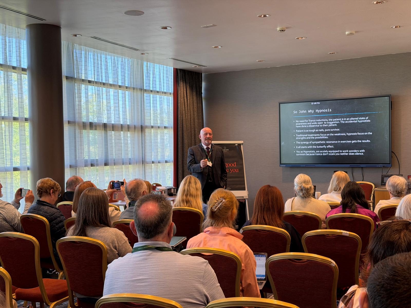 John A O'Connor speaking as an accredited International Speaker at a hypnotherapy conference